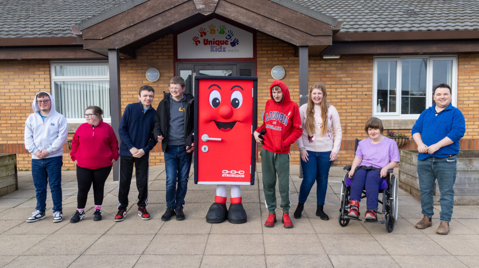 Strongdor team and mascot with Unique Kidz and Co