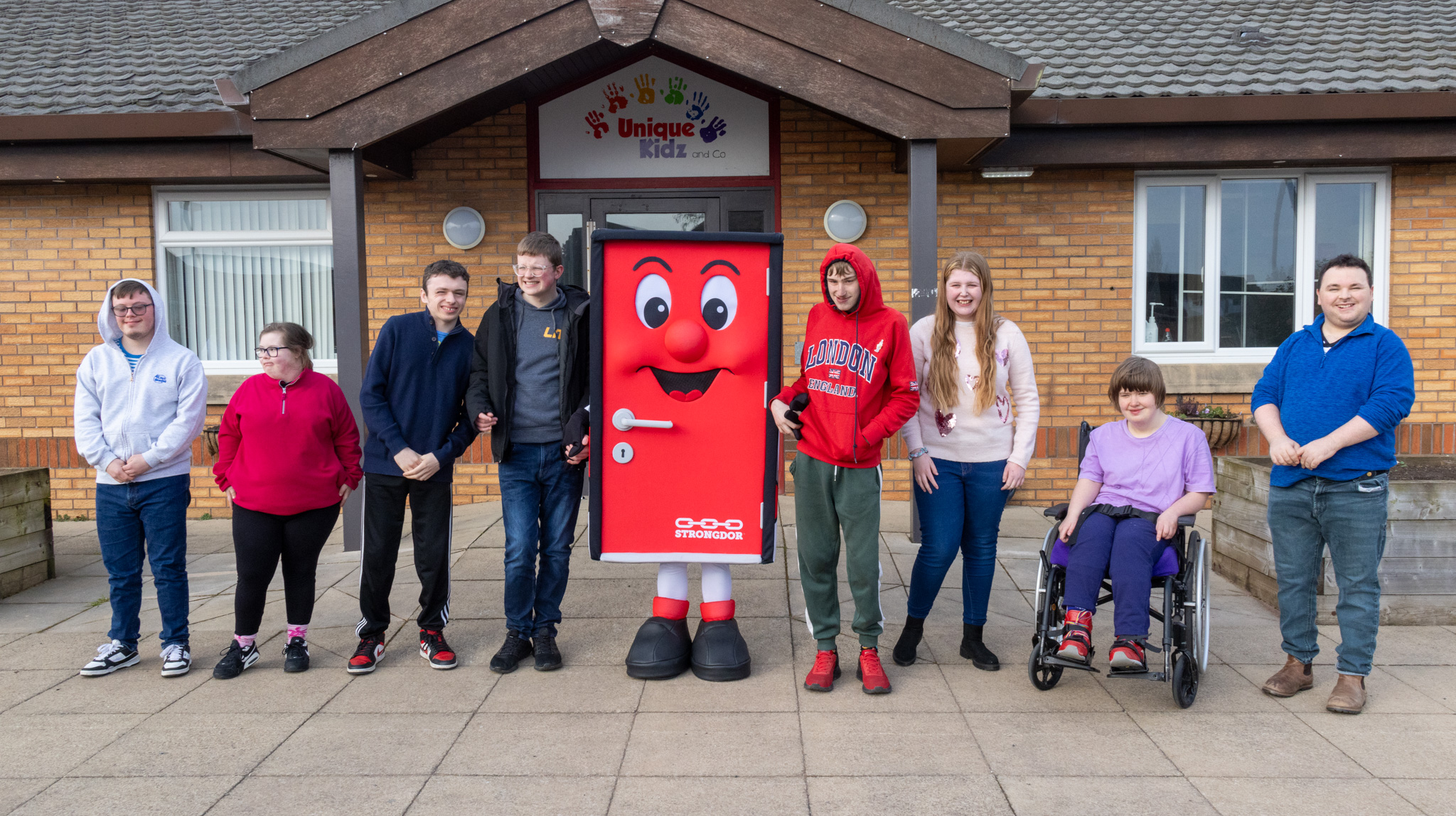 Strongdor team and mascot with Unique Kidz and Co