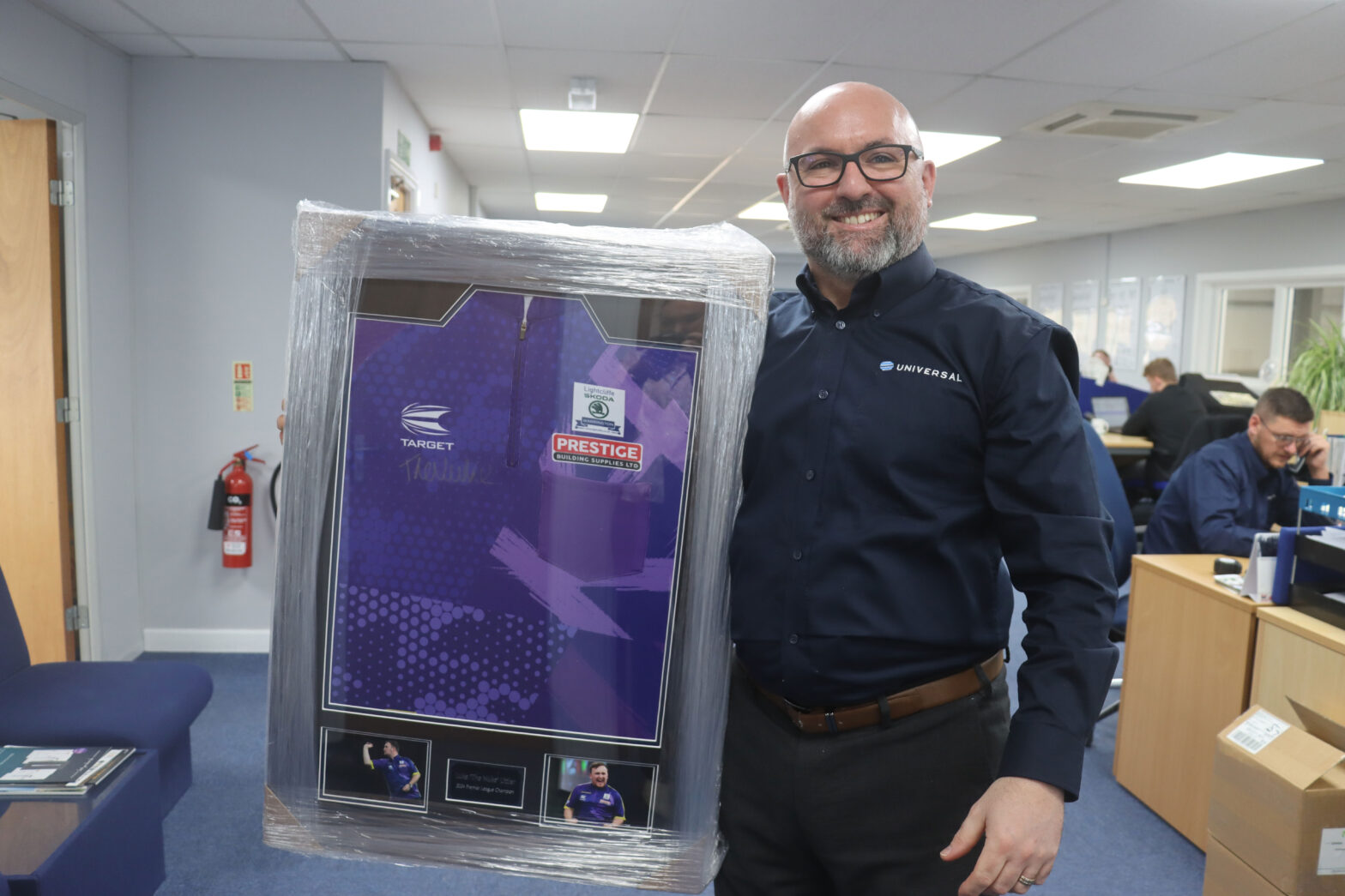 Richard Hammond of Universal Trade Frames with the signed Luke Littler shirt