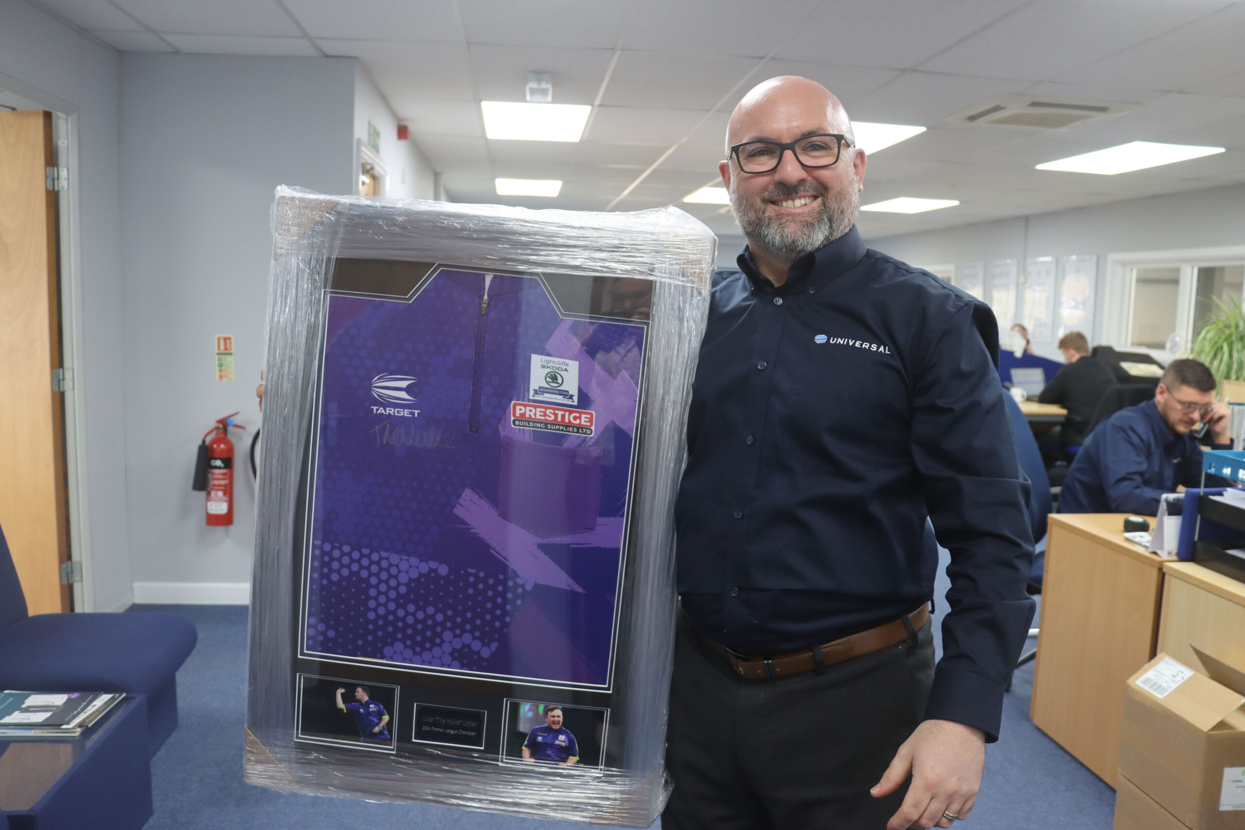 Richard Hammond of Universal Trade Frames with the signed Luke Littler shirt