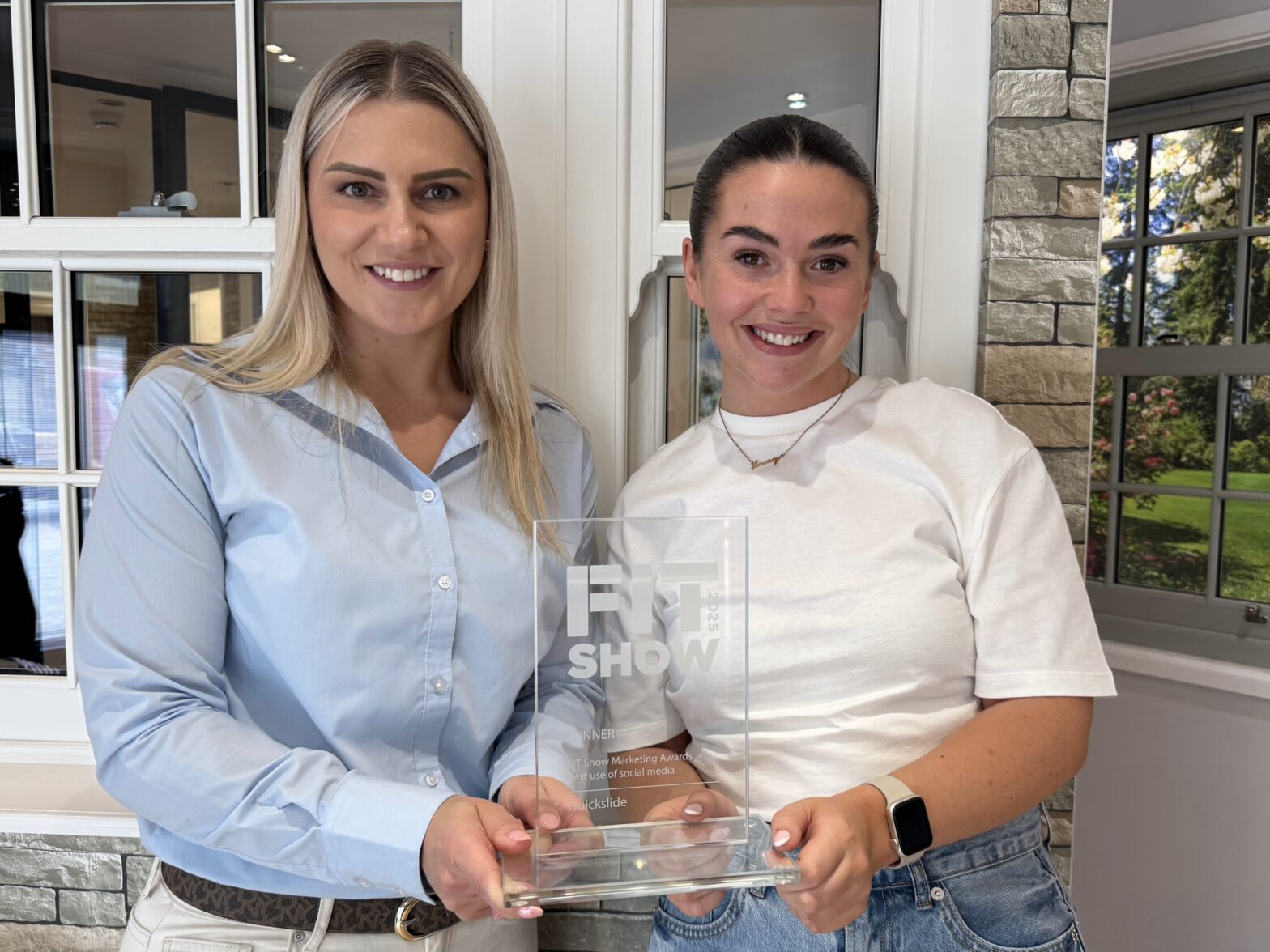 Sandra Berg and Lucy Chisem holding the FIT Show marketing award